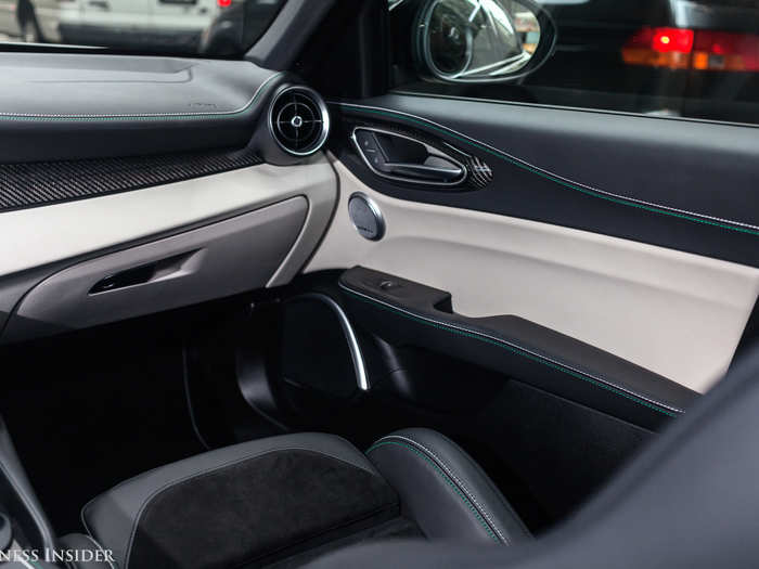 The front-seat passenger is enveloped in curvaceous, two-tone luxury.