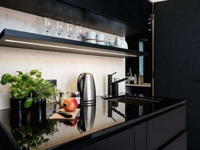 The kitchen has an oven, stovetop, drawers, and cabinets.