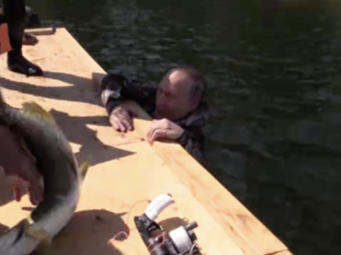 He then throws the trophy fish on the boat and hangs off the side. At one point, he appears to lose his grip and struggles to hold on as the fish flops around on the deck of the boat.