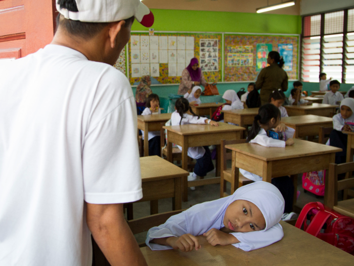 Malaysia: A student lays her head on the table during the first day of school in Kuala Lumpur.