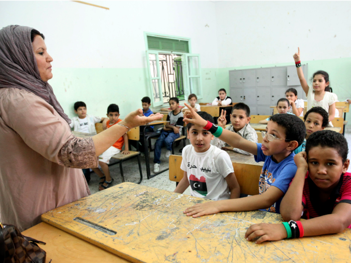 Lebanon: A teacher speaks to her students in a classroom on the first day of a new school term in Tripoli.