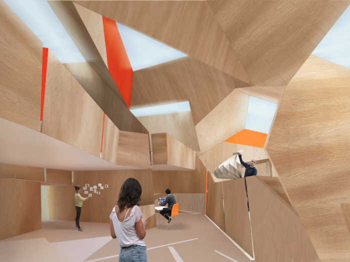 The interior contains a jagged mixture of natural wood and bright oranges and reds. The school caters to students pursuing higher education in arts and design.