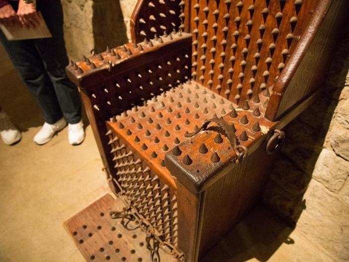 There are two original artifacts in the torture room. Interrogators would strap their prisoners into this prickly chair and light a fire underneath, causing them to squirm.