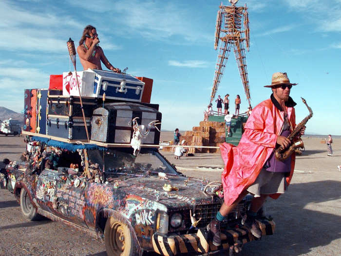 In the 1997 photo below, the man with a pink trench coat and saxophone was literally connected to his art car.