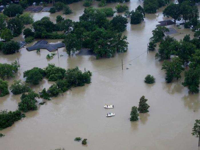 Professional and volunteer rescuers traveled the Houston area in boats, plucking desperate residents out of floodwaters and off of roofs.