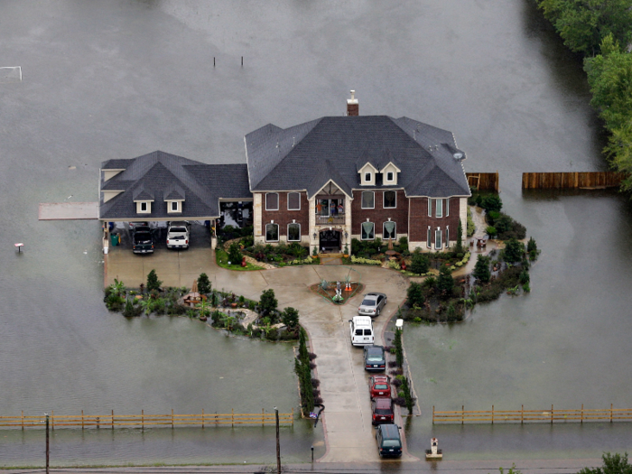 Houses built on higher elevation, like this one in Houston, fared better — though the surrounding land and roadways were still inundated.