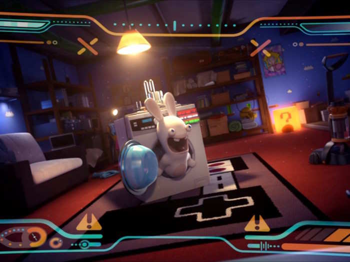 The Rabbids use a time-traveling clothes washing machine to get around. Here they are arriving in the office/living room of the Nintendo superfan.