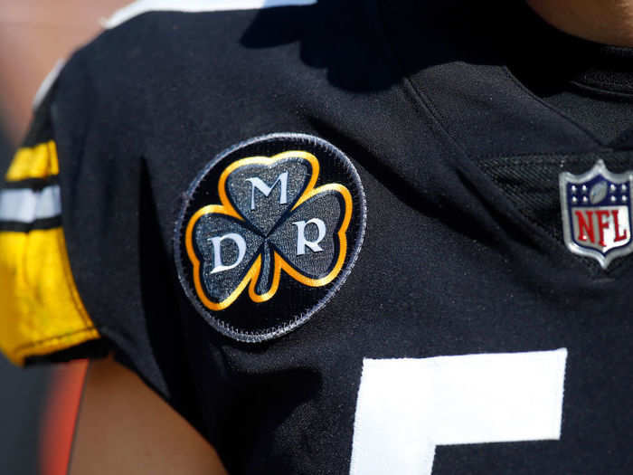 The Steelers are wearing a patch in honor of Dan Rooney who died earlier this year.