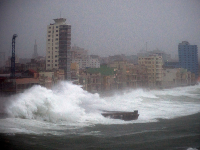 Cuba evacuated a million people from vulnerable areas, but massive storm surge waves flooded the island, destroying trees and buildings and killing at least ten.