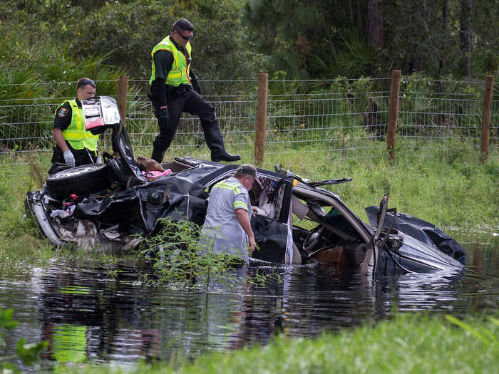 In North Port, police officers tried to salvage a car that had been swallowed by the storm.