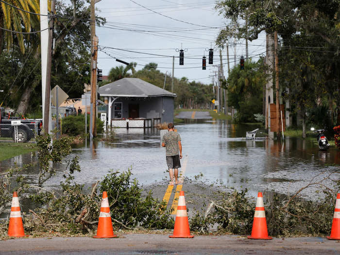 In Daytona Beach, a man waded into a flooded residential street.