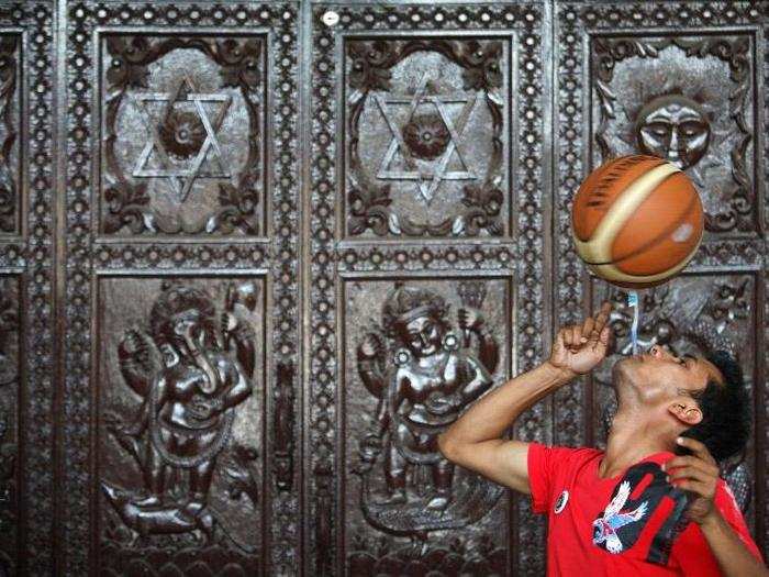 Thaneshwar Guragai spins a basketball on a toothbrush while holding it in his mouth for exactly 22.41 seconds.