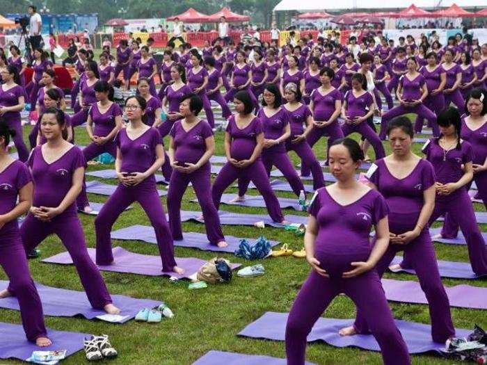 This group of expecting moms practice yoga as they attempt to break the Guinness World Record for the largest prenatal yoga class. The current record is 553 participants.