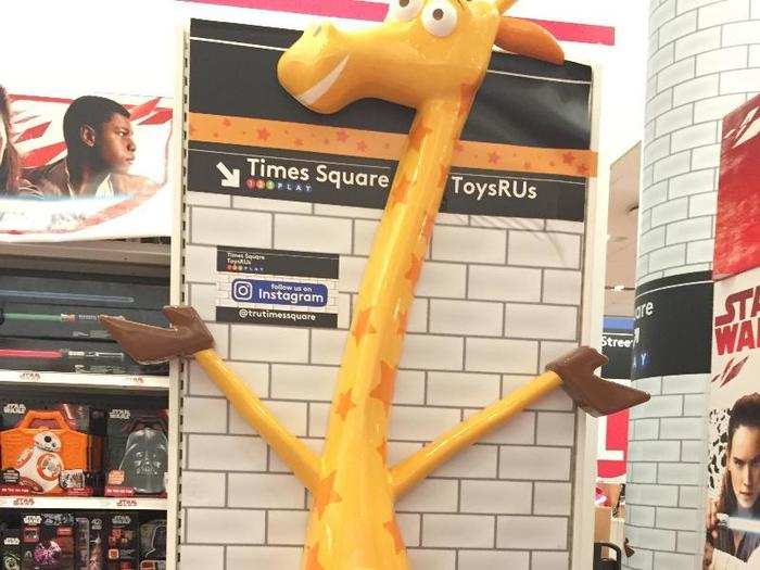 A giant Geoffrey the Giraffe encourages visitors to take a selfie.