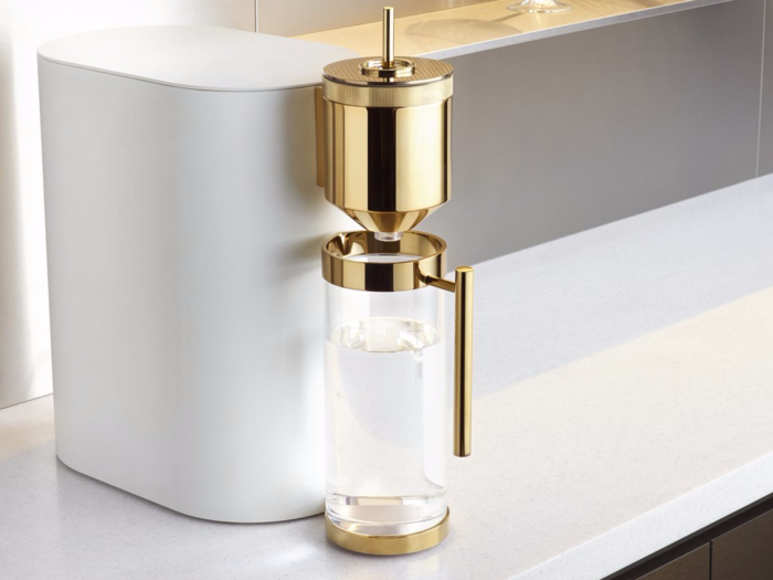 STANCE is a hot water filter and dispenser made by Kohler. The clean white body and gold-finished design are meant to echo the simplicity of both water and the device