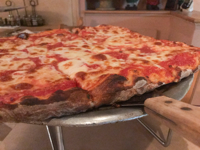 I ordered the Sicilian-style, cheese pizza and was not disappointed. The crust was flavorful, doughy and smothered in fresh tomato sauce. The hype around this place is well-earned. So who won the challenge?