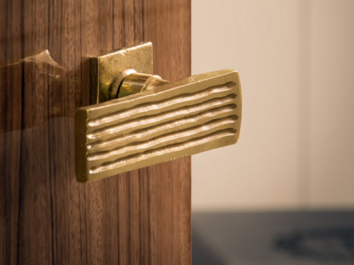 The developers of the building spared no expense. Residents will enter through a  Paldao wood door. The polished brass handle was custom-forged by Parisian artists.