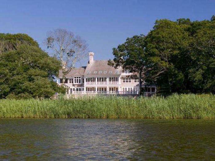 Elevated on a two-acre site with over 200 feet of waterfront on Georgica Pond, it