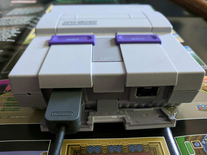 Instead, you flip down a panel and use these far more modern ports. Nintendo swapped the original SNES game pad plugs for these instead — the same ones Nintendo has been using since the Wii.