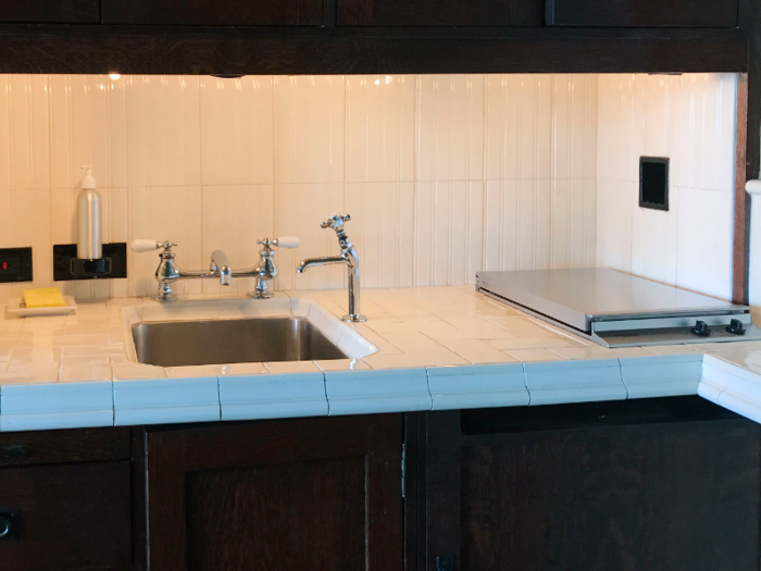 The electric stove is on the right-hand side of the kitchen counter. Many studio spaces are designed this way to conserve room while also allowing the residents to still cook homemade meals.