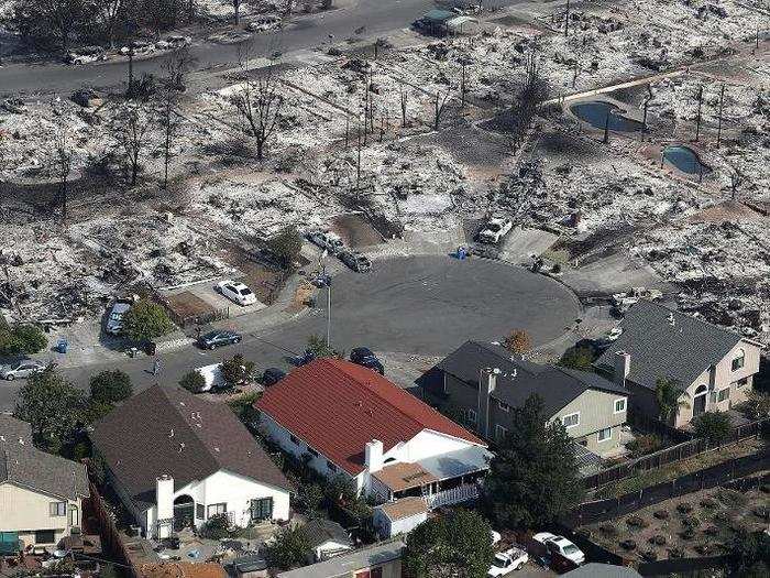 From above, you can make out the erratic nature of the burn. In a cul-de-sac, homes on one side of the street were charred in the flames, but a colorful few appeared to be unscathed.