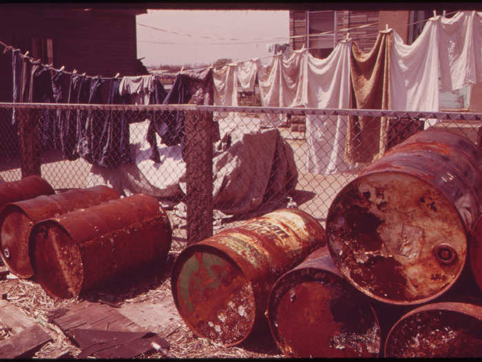 Rusty oil cans piled up near a home in a Jamaica Bay neighborhood. Today, the EPA sets standards on waste produced by oil and gas industries, with the goal of limiting public health hazards.