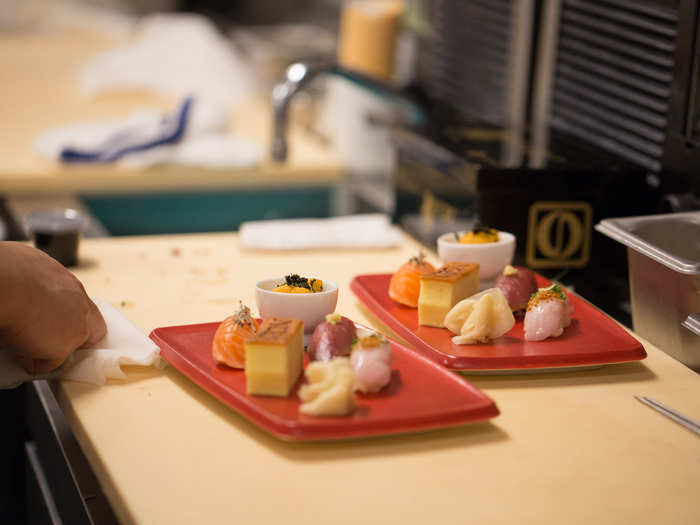 We watched as a chef plated a sashimi sampling with precision.