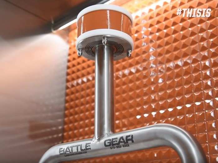 Underneath the helmet and pads is a custom-made Battle Gear rack with a cooling fan at the top to help dry the helmets.