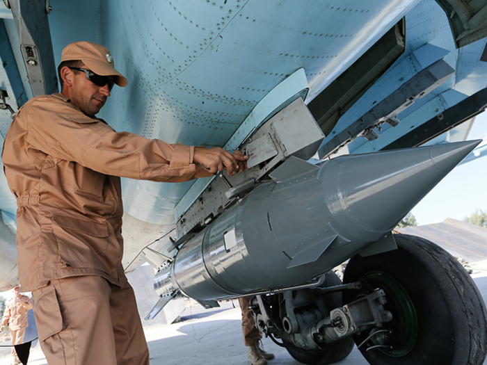 The picture shows a Russian airman checking a KAB-1500 cluster bomb on an Su-34 in Syria in 2015.