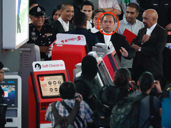 Malaysian deputy public prosecutor Muhammad Iskandar Ahmad, seen in the center, was also seen at the check-in kiosk.