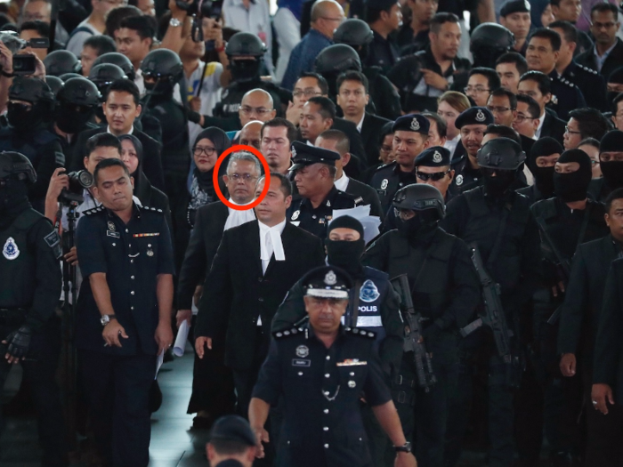 The defendants were not the only people brought to the airport. High court judge Azmi Ariffin, seen below in glasses, toured the scene as well.