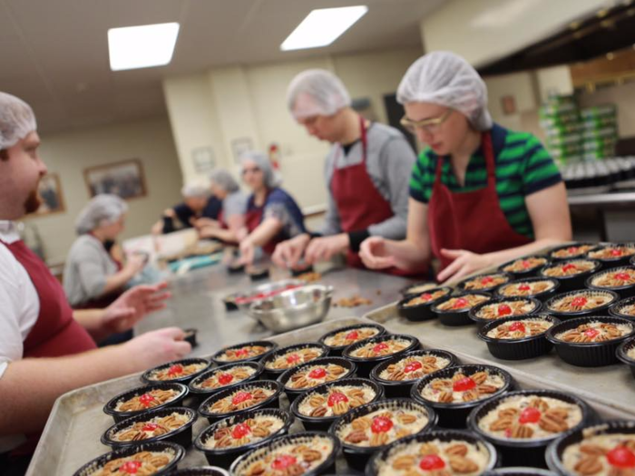 The Fruitcake and Jelly Kitchen has produced its famous fruitcake since 1934, and students bake more than 25,000 cakes a year, according to the school.