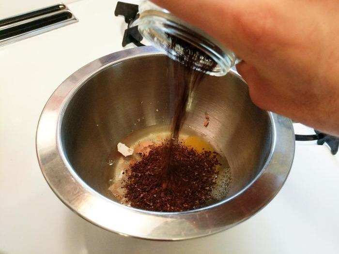 Add the ground coffee, along with about 1/4 cup of cold water.