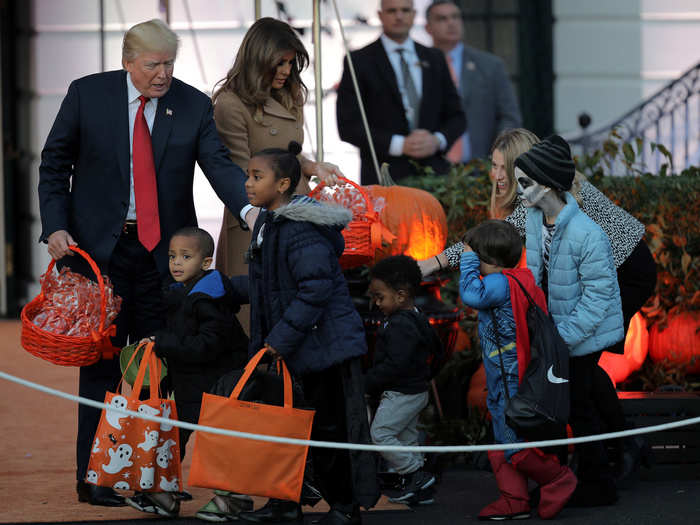 The wave of zombies, pirates, and other costumed children gathered to receive their loot.