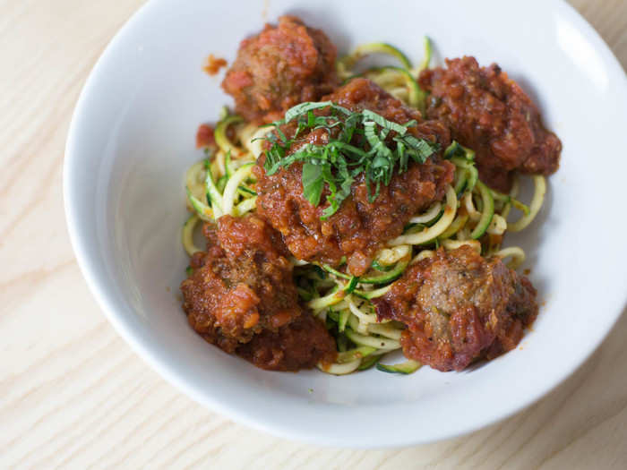 Most of the dishes take familiar comfort foods and swap in healthier ingredients. Spaghetti and meatballs becomes "zoodles" (zucchini noodles) and grass-fed beef meatballs.