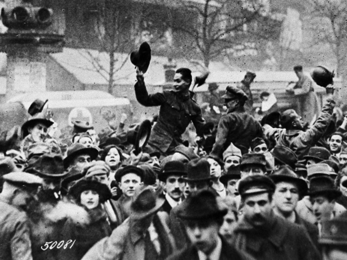 The war ended on the 11th hour of the 11th day of the 11th month of the year in 1918, when the final armistice was signed. Here, people celebrate the war