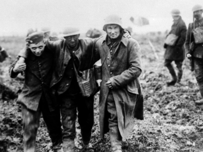 Amid the destruction and horror of World War I, some soldiers managed to maintain their humanity. Here, German soldiers carry wounded Canadian troops, who were fighting against them, to safety so they can recover in April 1917.