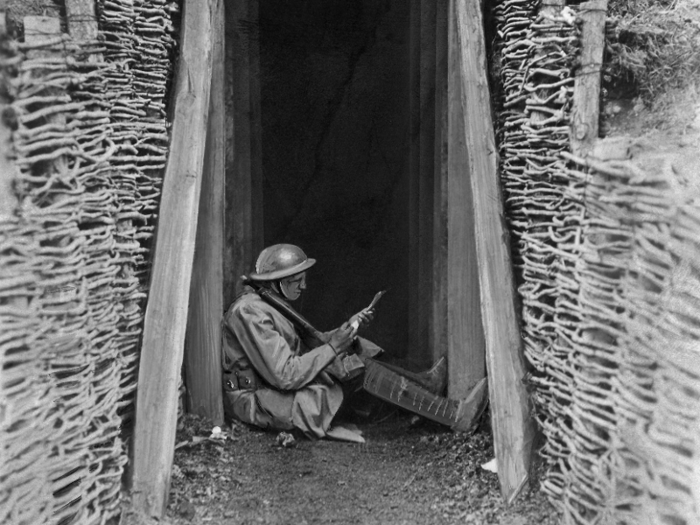 For the first time in history, grueling trench warfare became a defining characteristic of war. A US artilleryman uses some downtime in a trench in France to write home to his family on March 7, 1918.