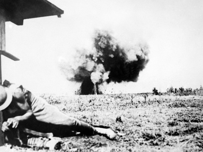 Battlefield engagements were stop-and-go in World War I. Here, a British soldier was stitching his shirt only be interrupted by a German shell landing nearby during the British army