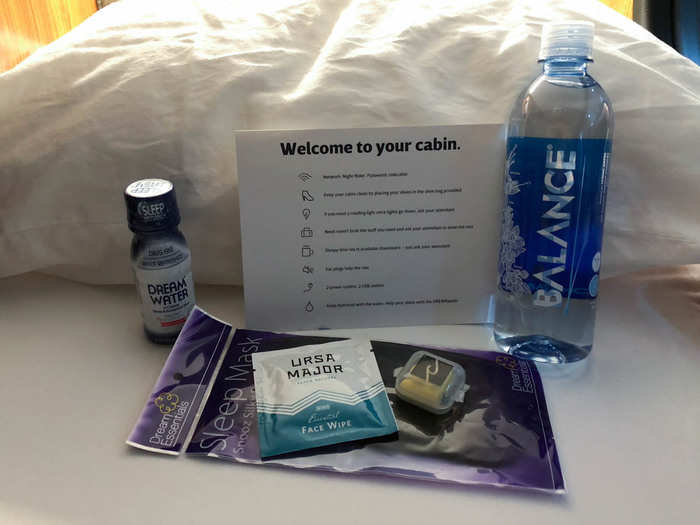 My reservation included some first-class amenities, including an eye mask, a face wipe, ear plugs, bottled water, and a shot-sized bottle of a melatonin-infused sleep aid called "Dream Water."