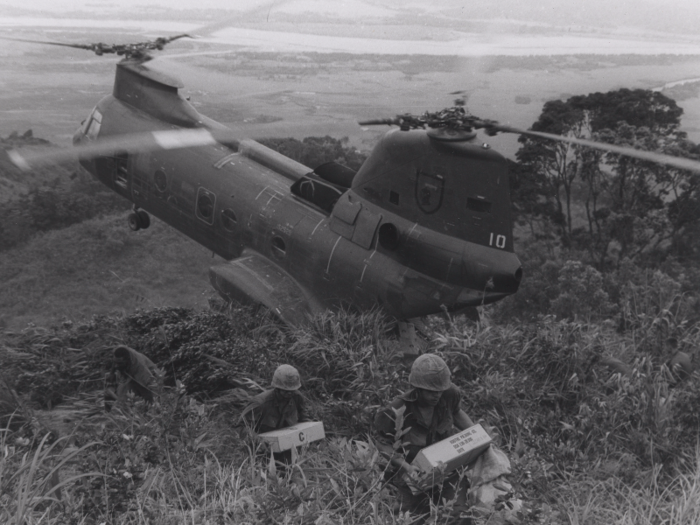 Marines carry supplies from a cargo helicopter to their temporary base near Da Nang in 1969.