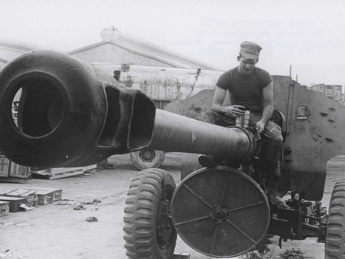 A Marine dismantles a 122 mm field gun that was captured during battle in 1969.