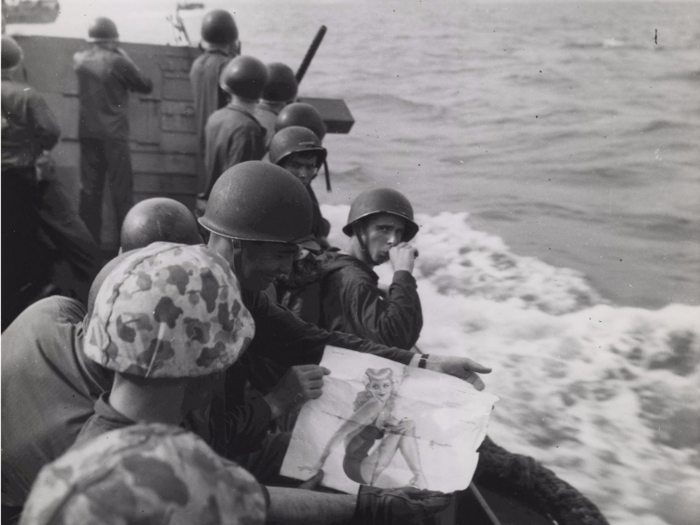 Marines on a landing barge take one last look at a "good-luck picture" of a pin-up girl in 1943 as they approach the Japanese-held island of Tarawa in the Pacific.