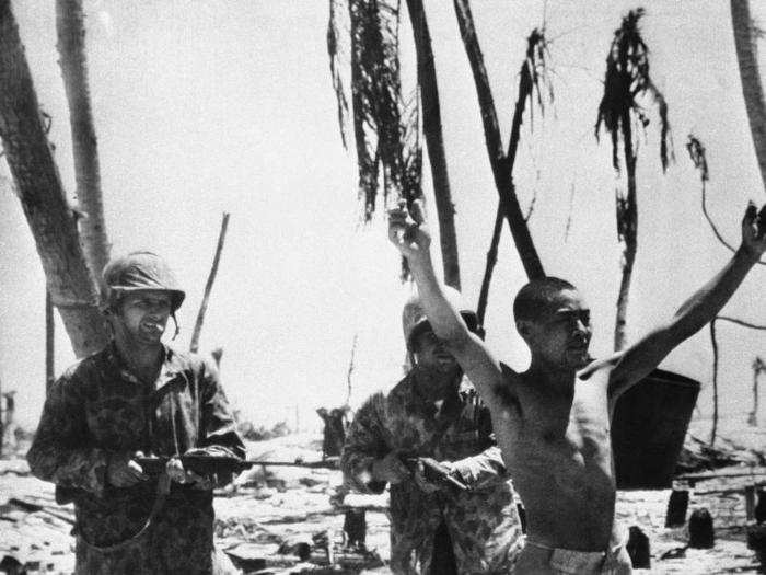 Landing forces continued to struggle ashore Betio; however, once joint Navy-Marine shore-fire-control teams landed, fire support improved considerably. One team called down fire on a group of Japanese soldiers crowded around a bunker, killing the commander of the island