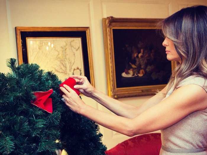 Trump also lent a hand to add a life-size bow. Thousands of volunteers assist staff for months to deck the halls of the White House.