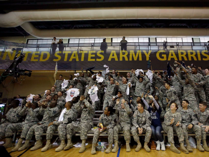 College sports teams often visit the camp to entertain the troops. Here, soldiers cheer during a game between two visiting US university basketball teams – Georgetown and Oregon — in 2013.