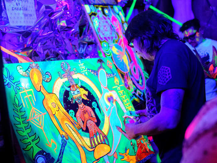 Painter Myztico Chango, who specializes in black light art, was working on a painting on the side of the dance floor. Chango was so inspired by the theme that he asked HoY to let him paint at the party.