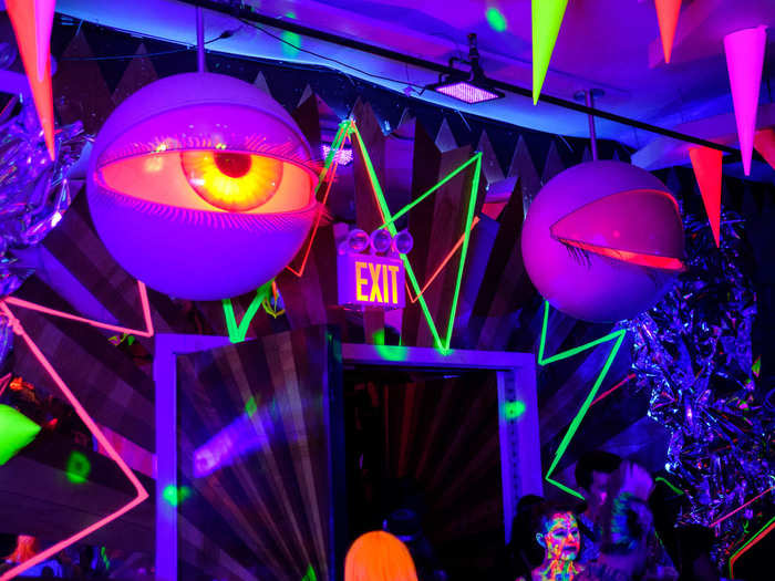 We dropped off our coats and headed to dance. This room, which doubles as an entrance, bar, and medium-sized dance floor, was all in blacklight. And those eyes opened and closed mechanically.