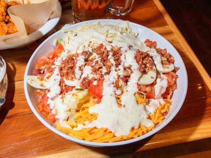 The salad is certainly large. The Hooters classic is essentially a Cobb salad. The abundance of iceberg lettuce is a bit disappointing, but an understandable choice to pair with the sauce-laden wings.