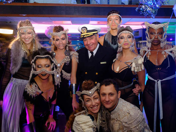 The yacht captain loved taking photos with the partiers. Those intricate headpieces were designed by fashion designer Saida Mouradova, who is at the bottom of the photo next to Che.